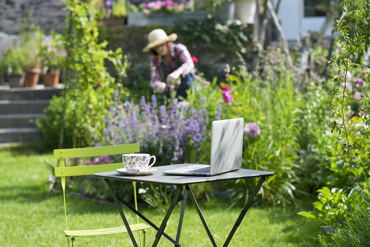 Women gardening with laptop on table